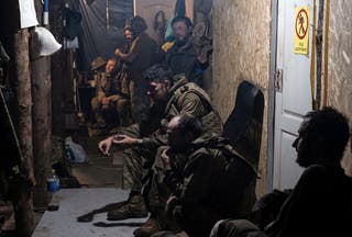 A handout photo made available by the press service of the 93rd 'Kholodnyi Yar' Separate Mechanised Brigade of the Ukrainian Armed Forces shows servicemen from the brigade resting inside a shelter at an undisclosed location near the frontline in the Donetsk region